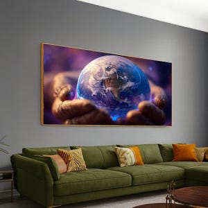 May include: A framed canvas print depicts a detailed image of planet Earth held in two hands. The artwork features a vibrant blue and white globe with continents visible, set against a purple and blue space background. The frame is gold.