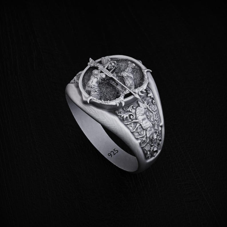 May include: A silver ring with a detailed design of two figures fighting with swords. The ring is engraved with the number "925" on the side.