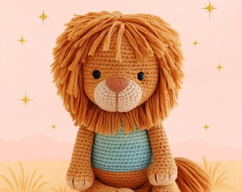 May include: A crocheted lion with a shaggy orange mane, sitting on a tan surface. The lion has a light blue shirt and a tan body. The text "CROCHET PATTERN Instant Download" is at the top of the image.