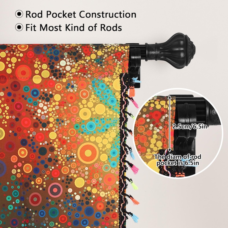 May include: A colorful curtain panel with a vibrant pattern of circles in shades of orange, yellow, blue, and brown. The panel has a rod pocket construction and fits most kinds of rods. The rod pocket diameter is 6.5 inches. The panel is trimmed with a black fringe and tassels.