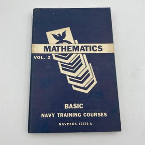 May include: A navy blue book titled "MATHEMATICS VOL. 2" with a gold band and insignia. The book is part of the "BASIC NAVY TRAINING COURSES" series, with the text "NAVPERS 10070-A" at the bottom. The cover features a stylized eagle and chevrons.