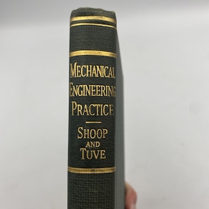 May include: A dark green hardcover book spine with gold lettering that reads Mechanical Engineering Practice, Shoop and Tuve. The spine features horizontal gold lines at the top and bottom, providing a clear view of the title and authors.