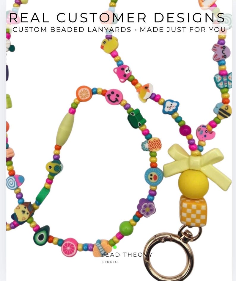 May include: A colorful beaded lanyard featuring various shaped charms including fruits, animals, and smiley faces. The lanyard includes a yellow bow, a yellow sphere, and a yellow and white checkered cube attached to a gold-toned metal lobster clasp.