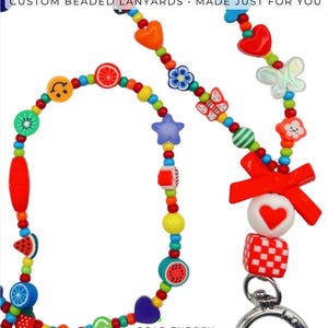 May include: A colorful beaded lanyard featuring various shapes including hearts, stars, butterflies, fruit slices, and a red bow. The lanyard includes text reading REAL CUSTOMER DESIGNS CUSTOM BEADED LANYARDS MADE JUST FOR YOU and BEAD THEORY STUDIO.