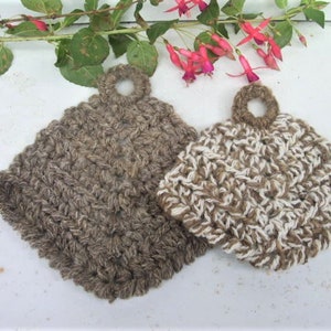 May include: Two crocheted pot holders with a loop handle. One is brown and the other is brown and white.