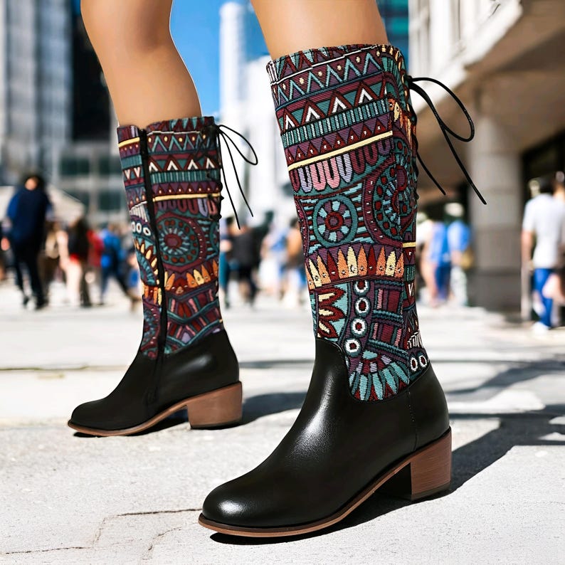 May include: Black leather boots with a colorful patterned fabric shaft. The boots have a block heel and a lace-up back.