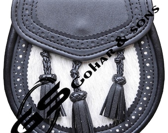 May include: A black leather sporran with a white fur front and three black tassels. The sporran has decorative stitching around the edges and a flap closure. The text "GOHAR & SONS" is visible.