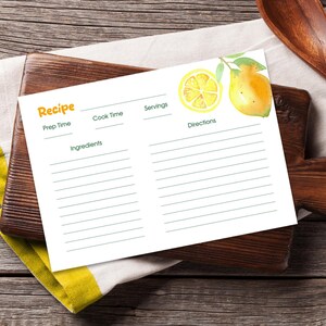 May include: A white recipe card with a watercolor lemon illustration. The card has sections for prep time, cook time, servings, ingredients, and directions. The word "Recipe" is in orange.