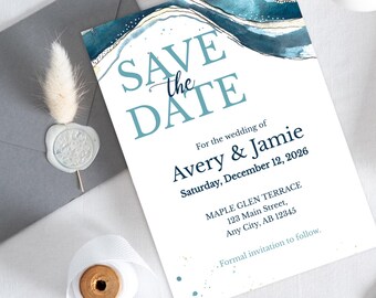 May include: A white wedding invitation with blue watercolor design and the text "Save the Date." The invitation includes the names Avery & Jamie, the wedding date, and venue address. A gray envelope with a wax seal is in the background.