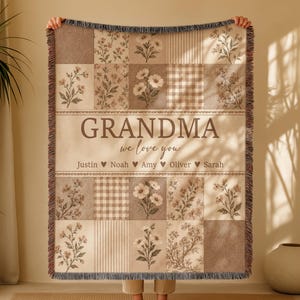 May include: A woven throw blanket featuring a patchwork design of floral patterns, stripes, and gingham checks in beige and brown tones. The center displays the text "GRANDMA we love you" followed by the names Justin, Noah, Amy, Oliver, and Sarah.