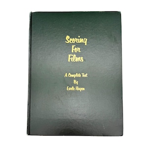 May include: A dark green book with the title "Scoring For Films" in gold lettering. The author is Earle Hagen. The book is a complete text on the subject of film scoring.
