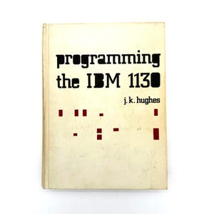 May include: Vintage book titled "Programming the IBM 1130" by J.K. Hughes. The cover is off-white with black text and red rectangular accents. The book is slightly worn, suggesting age and use.