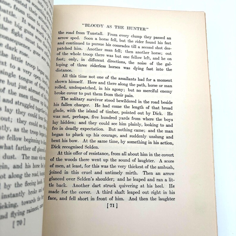 May include: Open book pages with text, featuring the title "BLOODY AS THE HUNTER." The text is in black font on aged, off-white paper. Page numbers are visible at the bottom. The book appears to be a vintage novel.