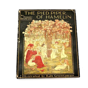 May include: Antique hardcover book titled "The Pied Piper of Hamelin" by Robert Browning, illustrated by Kate Greenaway. The cover features a colorful illustration of children dancing under a flowering tree, with a black border.