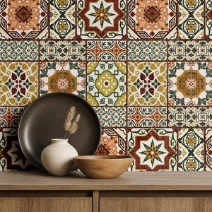 May include: A decorative arrangement featuring a dark brown plate, a small white vase with dried grass, and a wooden bowl. The background showcases a patterned tile design in shades of orange, green, and brown, creating a warm, inviting aesthetic.