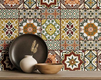 May include: A decorative arrangement featuring a dark brown plate, a small white vase with dried grass, and a wooden bowl. The background showcases a patterned tile design in shades of orange, green, and brown, creating a warm, inviting aesthetic.