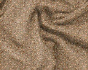 May include: A close-up of a fabric with a repeating pattern of small, stylized acorn shapes in shades of brown, tan, and orange against a muted olive green background. The fabric has a slightly wrinkled texture.