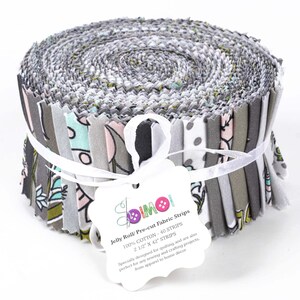 May include: A roll of pre-cut fabric strips in a variety of gray, white, and green floral patterns. The roll is tied with a white ribbon and has a label that reads "Jelly Roll/ Pre-cut Fabric Strips 100% COTTON - 40 STRIPS 2 1/2" X 42" STRIPS  Specially designed for quilting, and are also perfect for any sewing and crafting projects, from apparel to home decor."