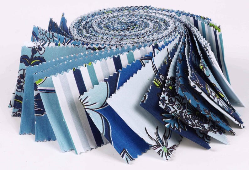 May include: A roll of blue and white fabric with various floral and striped patterns. The fabric is pre-cut into squares and is ready for quilting or other craft projects.