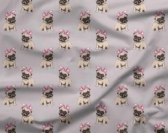 May include: A repeating pattern of beige pugs wearing pink bows on a light gray background. The pugs are sitting, facing forward. A ruler with inches and centimeters is at the bottom of the image.
