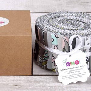 May include: A roll of gray and white fabric strips with a floral pattern. The fabric is labeled "Jelly Roll Pro-cut Fabric Strips" and is 100% cotton. The roll is 2.5 inches wide and contains 40 strips.