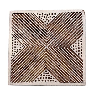 May include: A wooden printing block with a geometric design. The design features a white background with brown lines and dots.