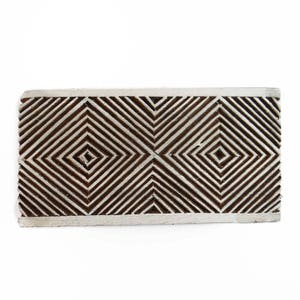 May include: A wooden block printing stamp with a geometric design of overlapping squares and diagonal lines. The stamp is brown and has a white border.