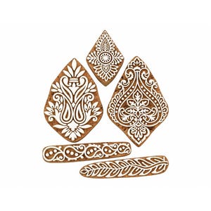 May include: A set of five wooden printing blocks featuring intricate white carved floral and paisley patterns on a natural brown wood surface. The collection includes two large teardrop-shaped blocks, one small diamond-shaped block, and two rectangular border strips.