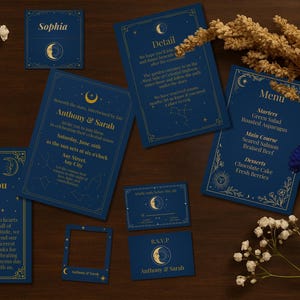 May include: Navy blue wedding stationery set with gold celestial designs. Includes invitations, menu cards, and thank you cards. The cards feature a moon and star theme, with the names "Anthony & Sarah" and "Sophia" printed on them.