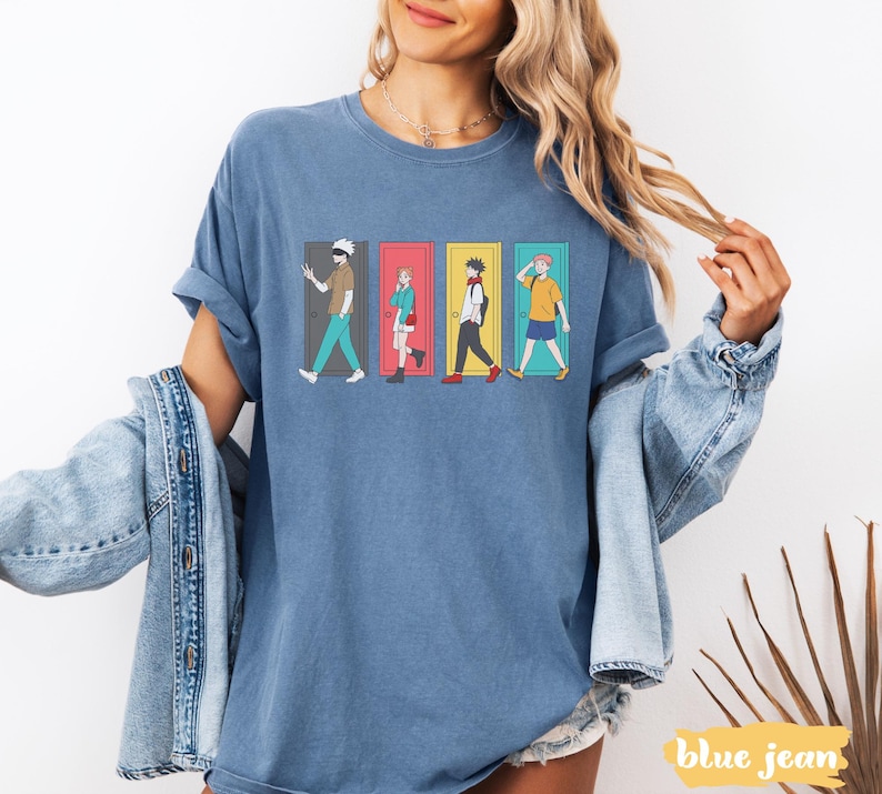 May include: Blue jean-colored t-shirt featuring a graphic of four anime characters walking through colorful doors. The characters are in different outfits and poses. The text "blue jean" is at the bottom right.