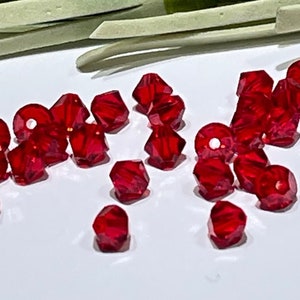 12 Light Siam Swarovski Crystal Beads: 4mm Bicone Xilion - July Birthstone
