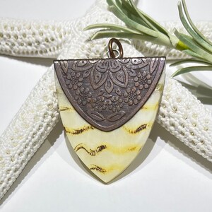 Creamy Beige Arrowhead Pendant: Antique Copper Detailed Bail