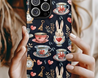 May include: A black smartphone case featuring a repeating pattern of white rabbits, red hearts, vintage-style teacups with floral motifs, gold keys, and round clocks. The design elements are arranged across the dark background in a whimsical style.