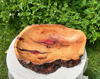Hand carved cherry live edge wooden serving bowl with cranberry epoxy inlay.