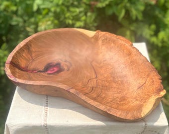 Hand carved cherry live edge wooden serving bowl with cranberry epoxy inlay.