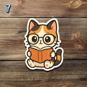 May include: A sticker featuring a cartoon cat wearing glasses and reading a book. The cat has orange, white, and black fur. The sticker is on a wooden surface. The number 7 is in the upper left corner.