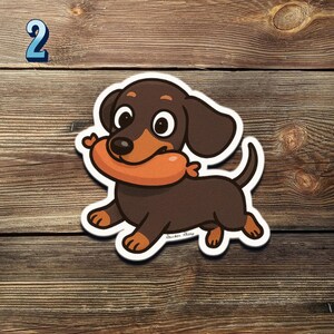 May include: A sticker of a cartoon dachshund dog with brown and tan fur, holding a sausage. The dog has a cheerful expression and is set against a wooden background. The number 2 is in the upper left corner.