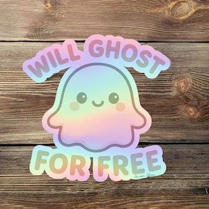 May include: A holographic sticker featuring a cute ghost with the text "WILL GHOST FOR FREE". The ghost is pastel-colored with a smiling face. The sticker is on a wooden background.