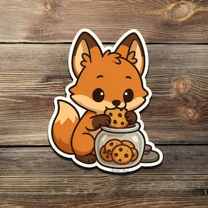 May include: A sticker featuring a cartoon fox with orange fur, brown ears, and a fluffy tail. The fox is holding a chocolate chip cookie from a glass jar filled with cookies. The sticker has a white border and is set against a wood grain background.
