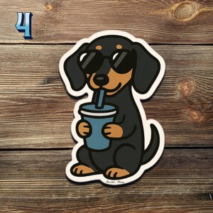 May include: A sticker of a cartoon dachshund wearing sunglasses, drinking from a blue cup. The dog is black and brown with a white outline. The number 4 is in the upper left corner.