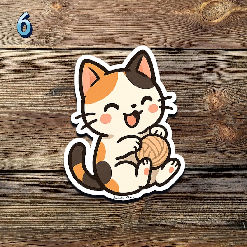 May include: A cartoon sticker of a happy calico cat holding a ball of yarn. The cat has orange, black, and white fur, with a smiling face and pink cheeks. The sticker is on a wooden background, with the number 6 in the upper left corner.