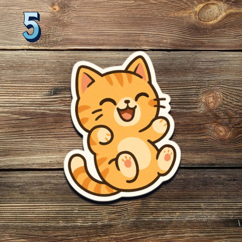 May include: A sticker featuring a cartoon orange tabby cat with a happy expression. The cat is sitting with its paws up and has a white border. The number 5 is in the upper left corner.