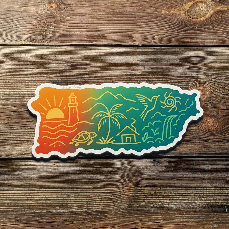 May include: A colorful sticker in the shape of Puerto Rico, featuring a sunset, lighthouse, palm tree, bird, and waterfall. The design includes the text "Sticker Shore" and a turtle. The sticker is on a wooden surface.