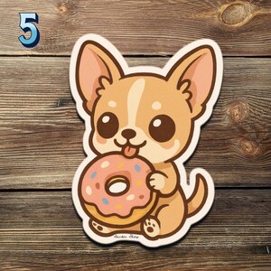 May include: A sticker of a cartoon chihuahua dog with a pink donut. The dog is light brown with big brown eyes and a pink tongue. The donut has pink icing and sprinkles. The number 5 is in the upper left corner.