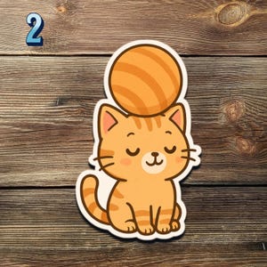 May include: A sticker featuring a cartoon orange tabby cat with closed eyes, a small smile, and a ball on its head. The number 2 is in the upper left corner. The sticker is on a wooden background.