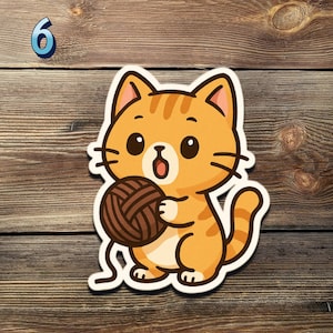 May include: A cartoon sticker of an orange tabby cat holding a ball of brown yarn. The cat has large eyes and a surprised expression. The number 6 is in the upper left corner. The sticker is on a wooden background.