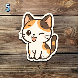 May include: A cartoon sticker of a winking cat with a white body, orange and brown patches, and a brown tail. The cat is sticking out its tongue. The number "5" is in the upper left corner. The sticker is on a wooden surface.