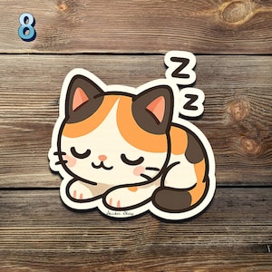 May include: A sticker featuring a cartoon calico cat sleeping peacefully. The cat has orange, brown, and white fur, closed eyes, and pink cheeks. Two white "Z"s float above the cat, indicating sleep. The number "8" is in the top left corner.