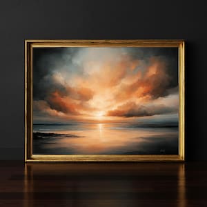 May include: A rectangular landscape painting in a gold frame depicting a sunset over a calm ocean. The sky is filled with dramatic, thick clouds in shades of orange, gold, and dark gray, with the sun casting a bright reflection on the water.