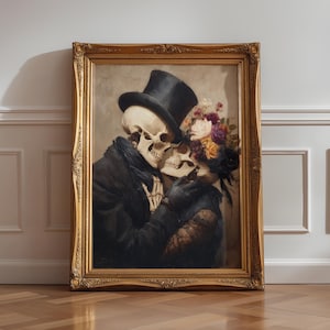 May include: A framed artwork depicts two skeletons embracing. One skeleton wears a top hat and black coat, the other a floral headpiece and black dress. The gold frame surrounds the romantic, gothic-themed painting.